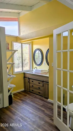 a view of a door and a mirror on the wall