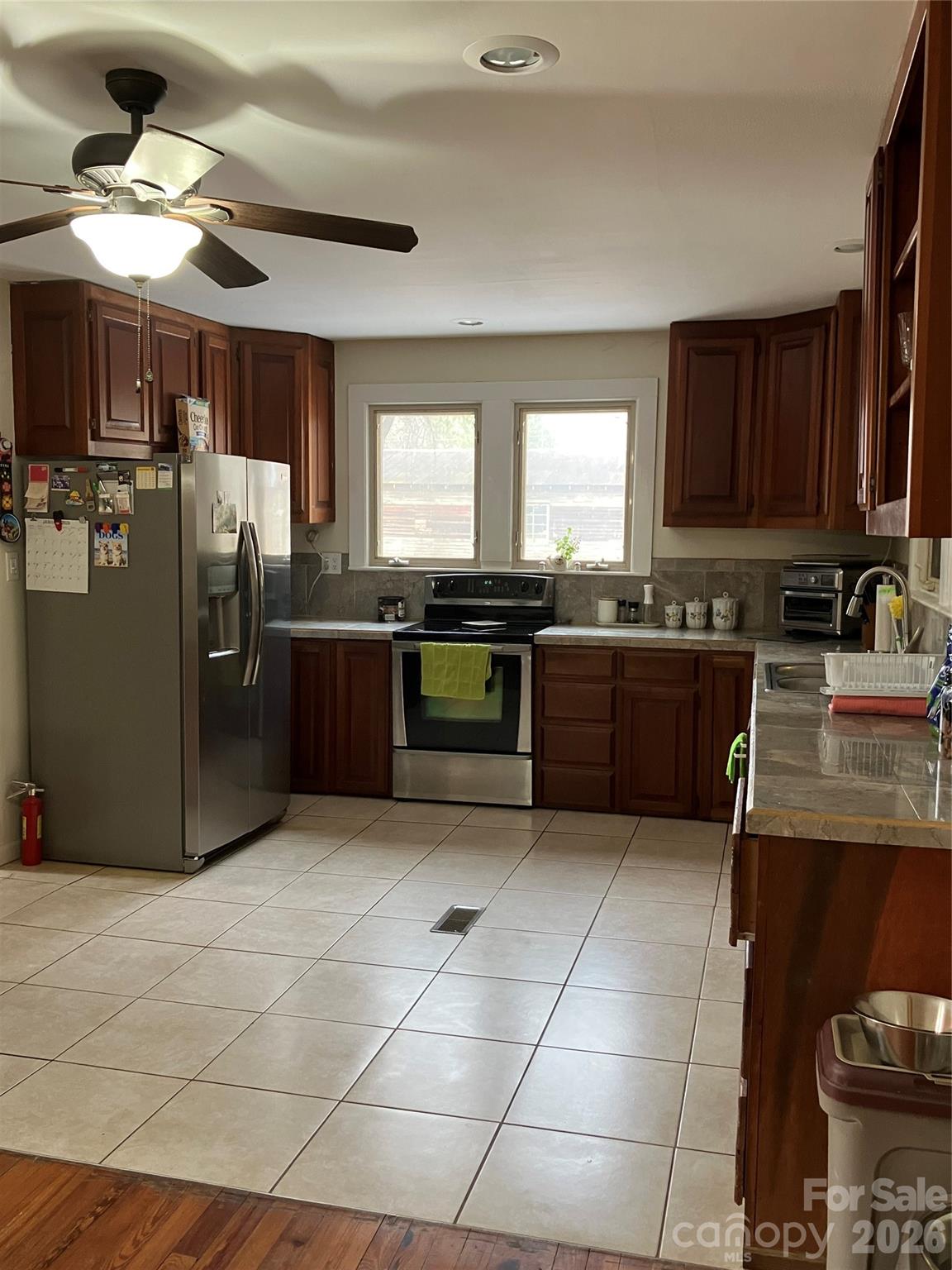 1719 Ridge Street Albemarle, NC 28001 - Photo 16 of 33 a kitchen with stainless steel appliances granite countertop a sink counter space cabinets and a window