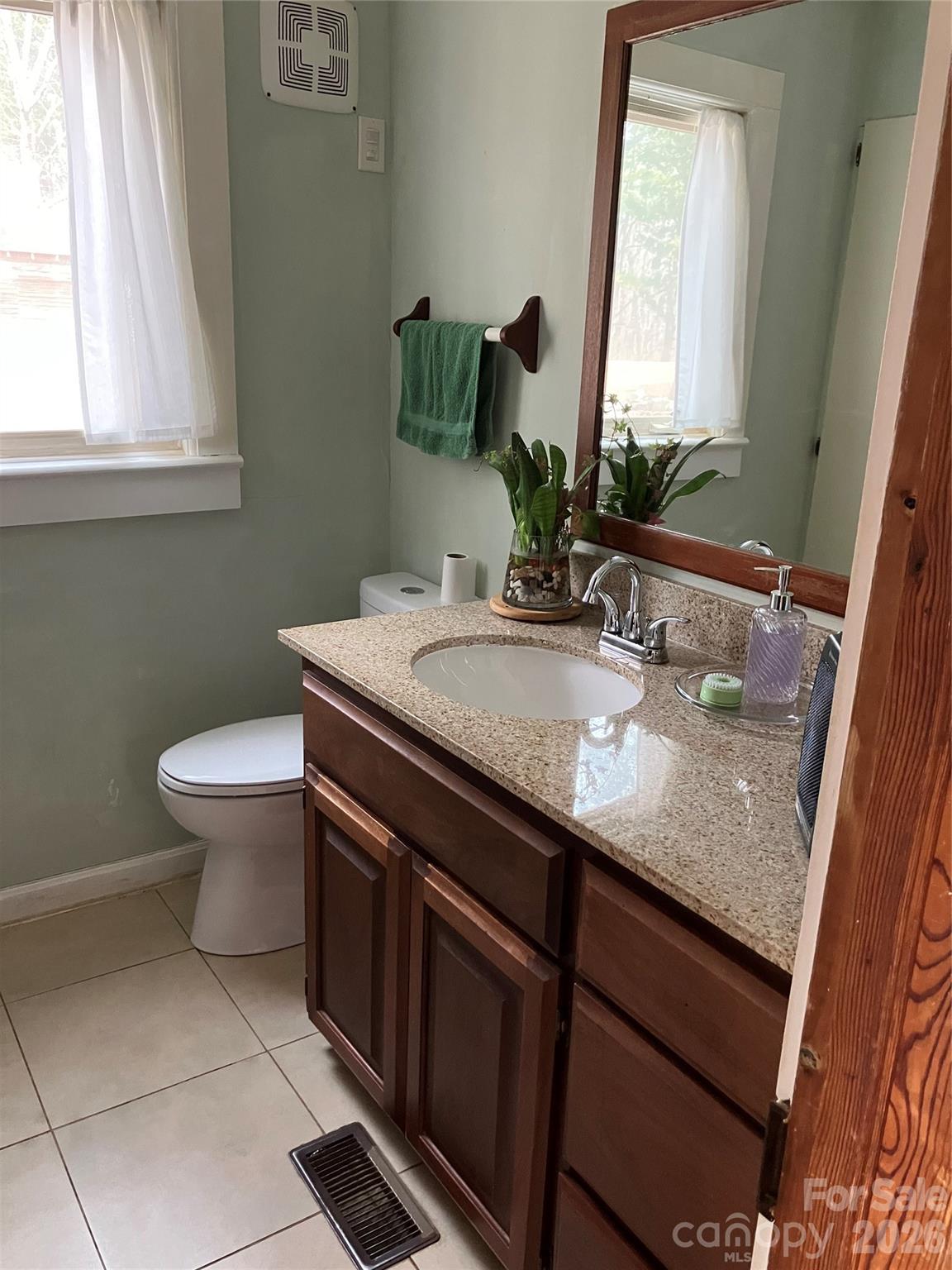 1719 Ridge Street Albemarle, NC 28001 - Photo 19 of 33 a bathroom with a granite countertop sink a toilet and a mirror