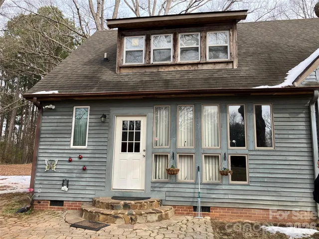 a kitchen with stainless steel appliances kitchen island granite countertop a refrigerator and a stove top oven