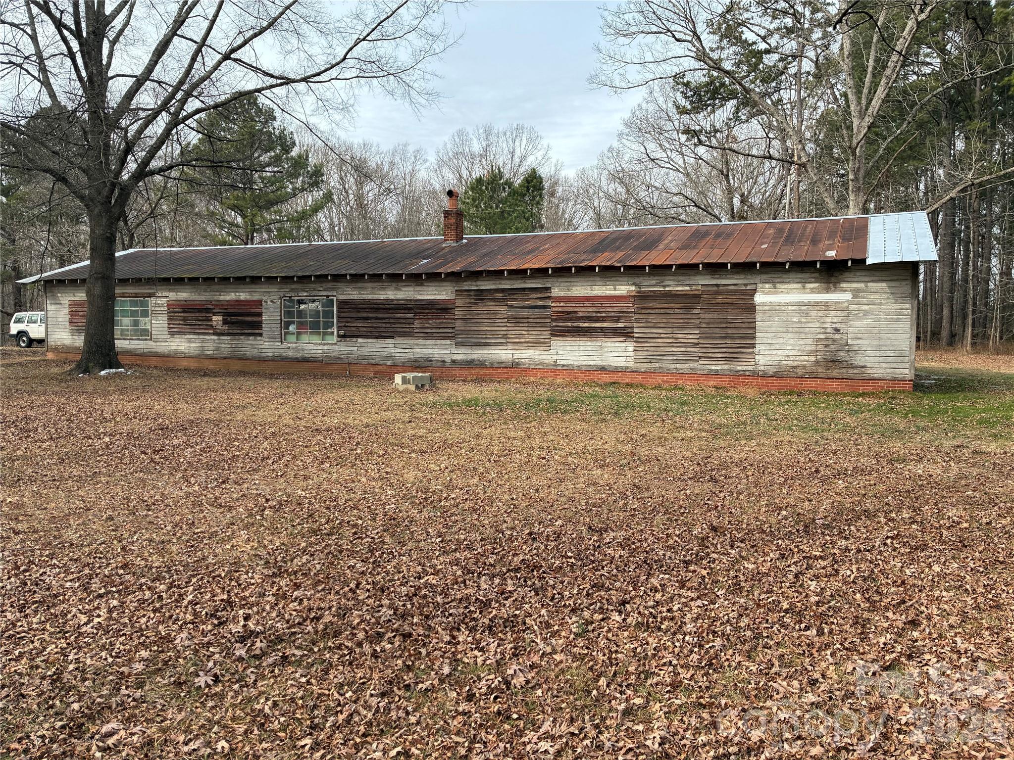 1719 Ridge Street Albemarle, NC 28001 - Photo 9 of 33 a backyard of a house with large trees and outdoor seating