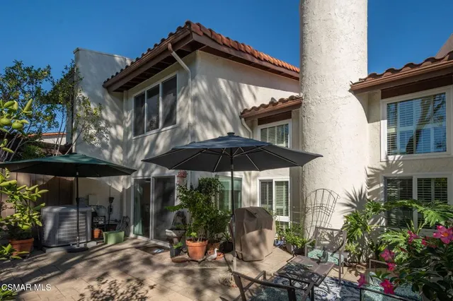 a view of a house with yard and sitting area