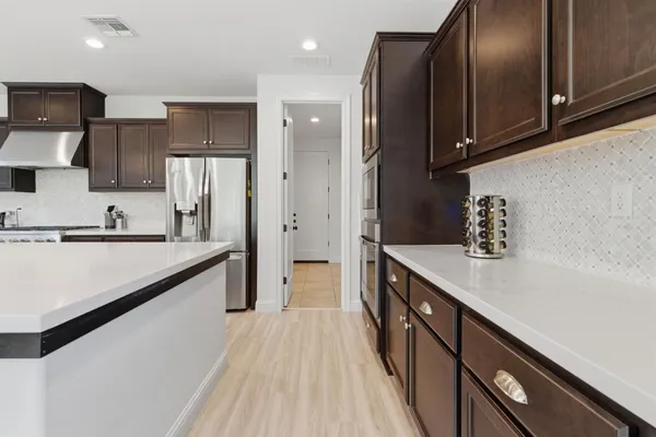 a living room with furniture and kitchen view