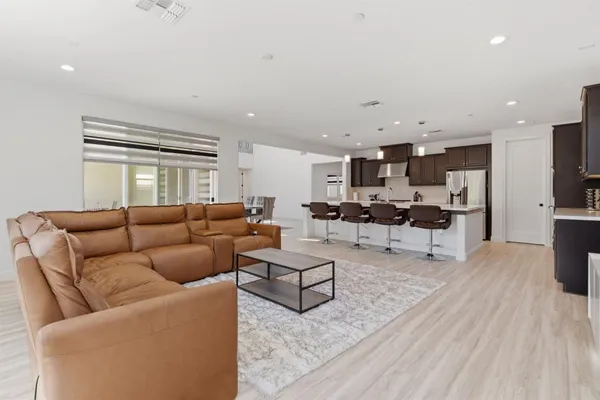 a bathroom with a sink a toilet a mirror and shower