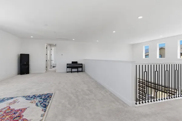 a view of a white house with a yard and potted plants