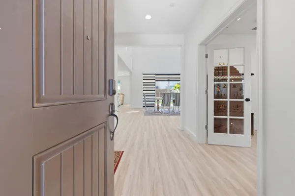 a kitchen with a table chairs and a wooden floor
