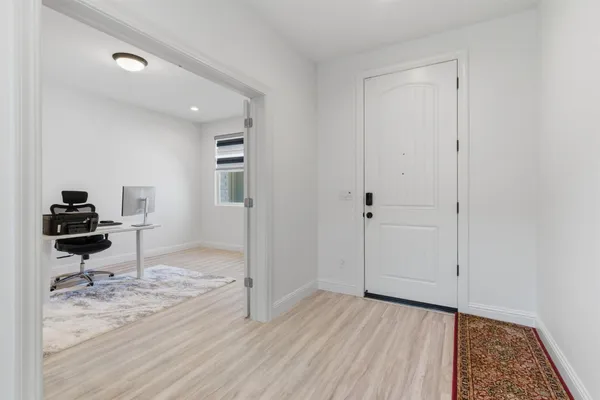 a dining room with furniture and wooden floor