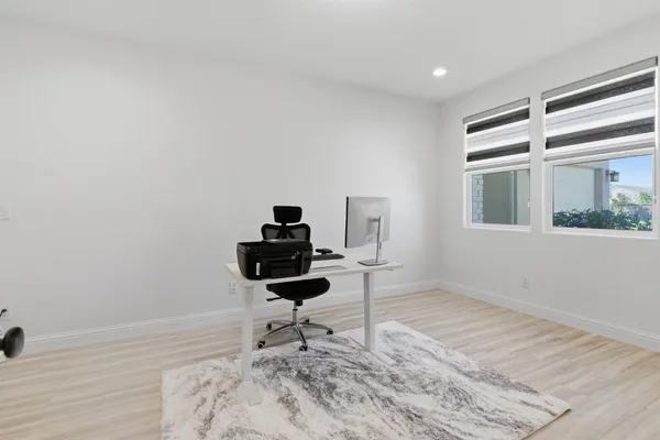 a dining room with furniture wooden floor and a rug