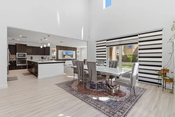 a kitchen with stainless steel appliances kitchen island granite countertop a sink a stove and a wooden floors