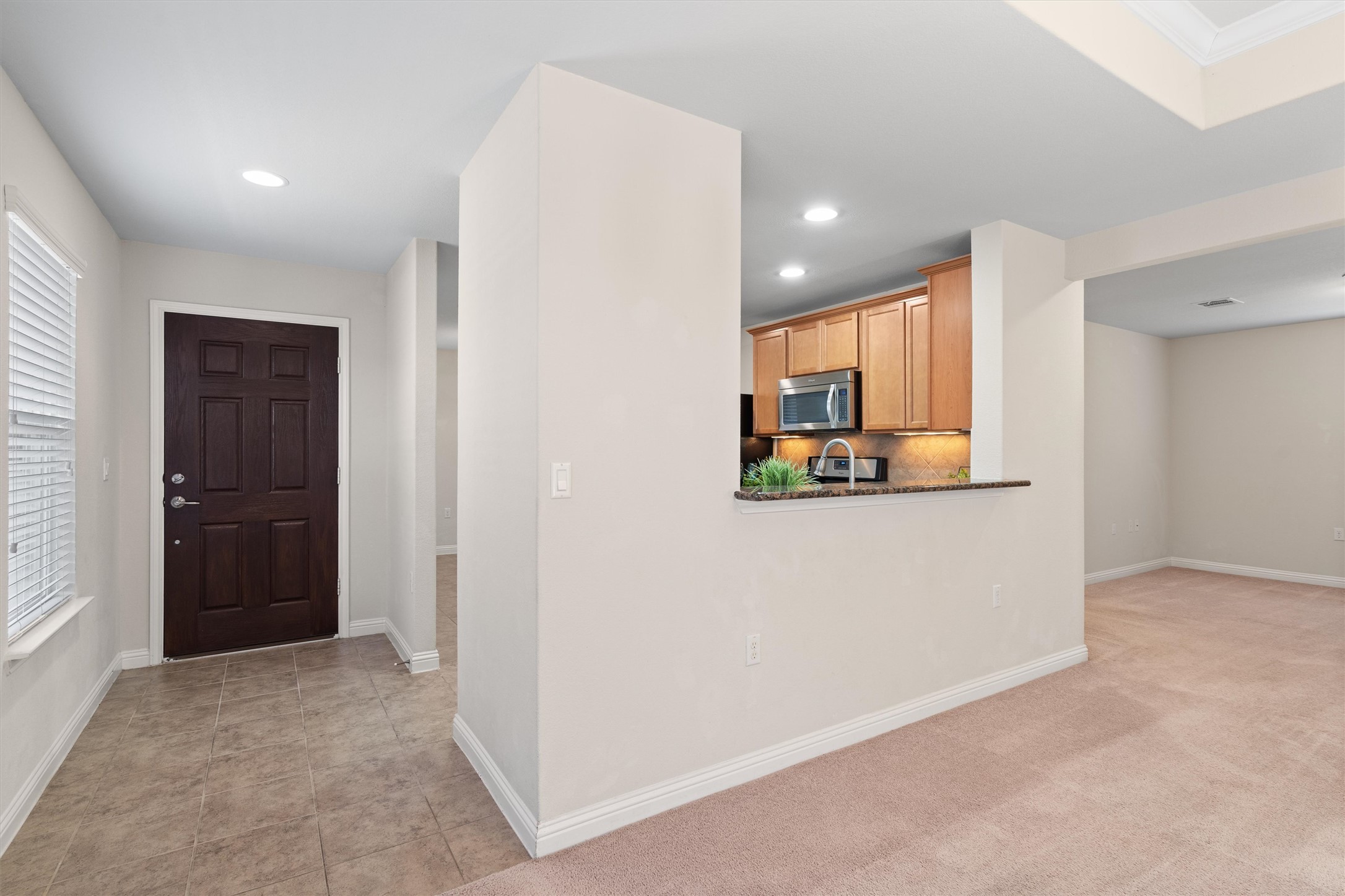 307 Kickapoo Creek Lane Georgetown, TX 78633 - Photo 4 of 30 An inviting entrance foyer transitions seamlessly into the carpeted living areas and adjacent kitchen.