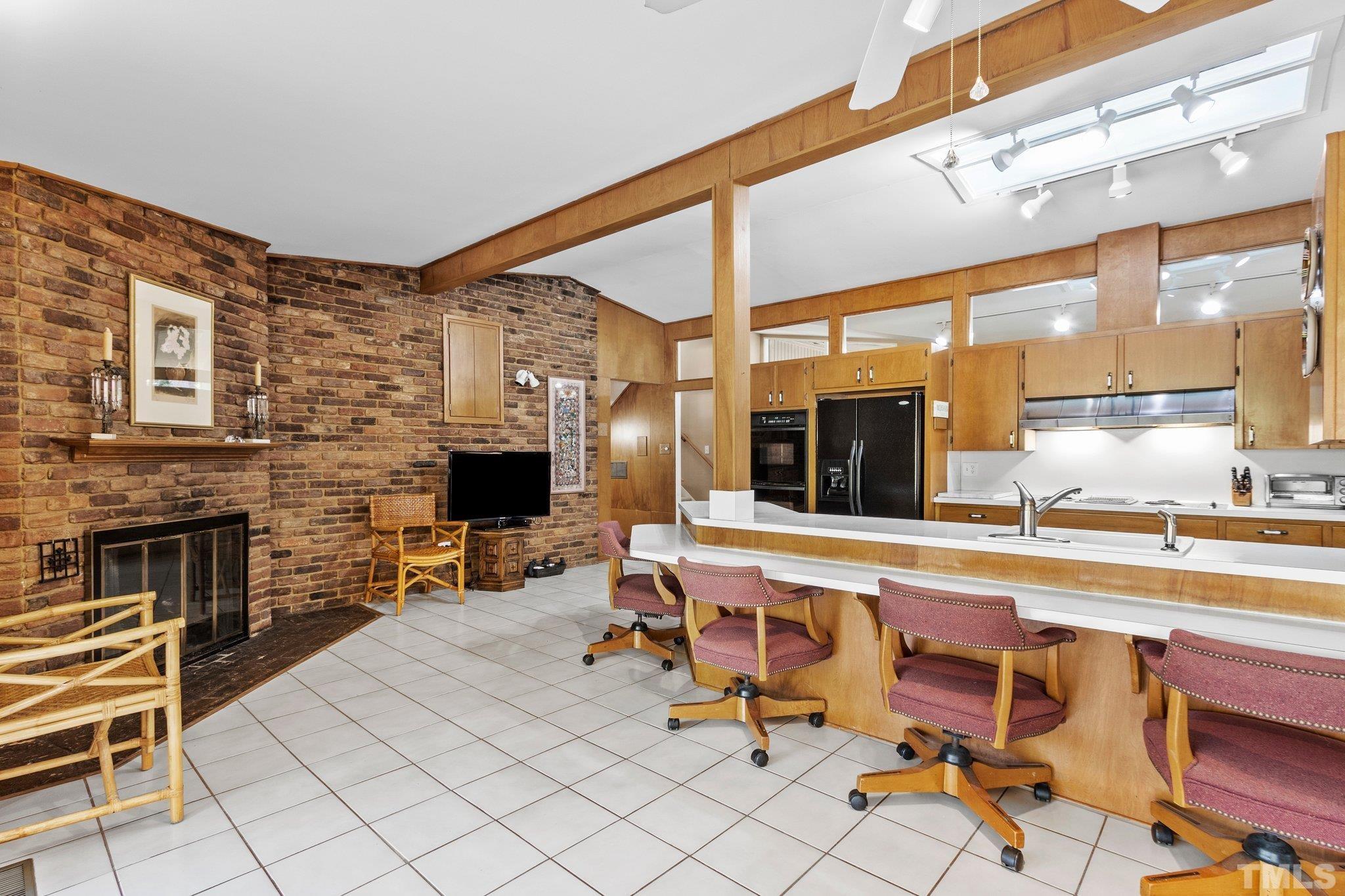 3310 Devon Road Durham, NC 27707 - Photo 16 of 50 Open kitchen with fireplace provides wonderful gathering space.
