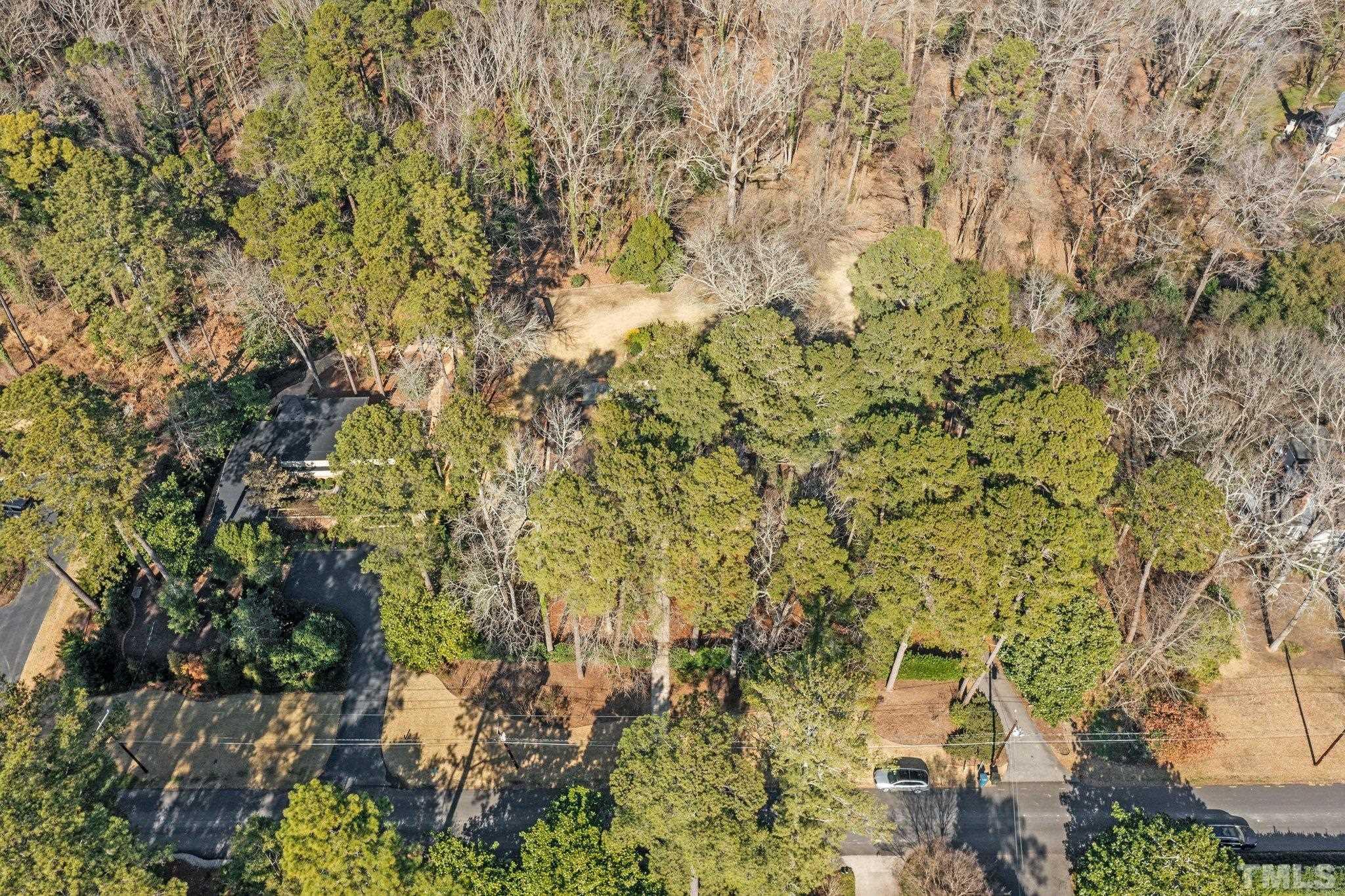 3310 Devon Road Durham, NC 27707 - Photo 33 of 50 The front of the house is nestled into the trees for privacy but opens to the rear to a large lawn.
