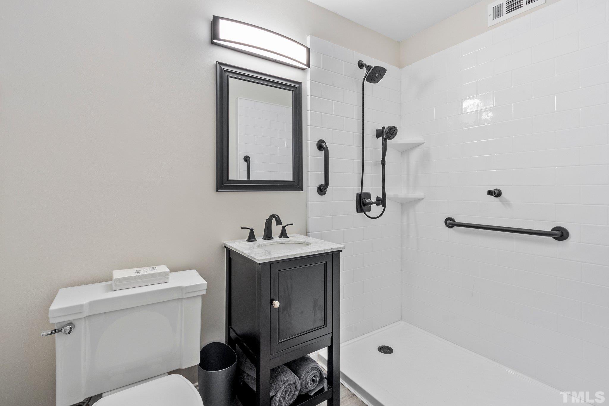 3310 Devon Road Durham, NC 27707 - Photo 45 of 50 Delightful bath with large shower has clever barn door ! This bath is located within the home office which could also be a 5th BR.