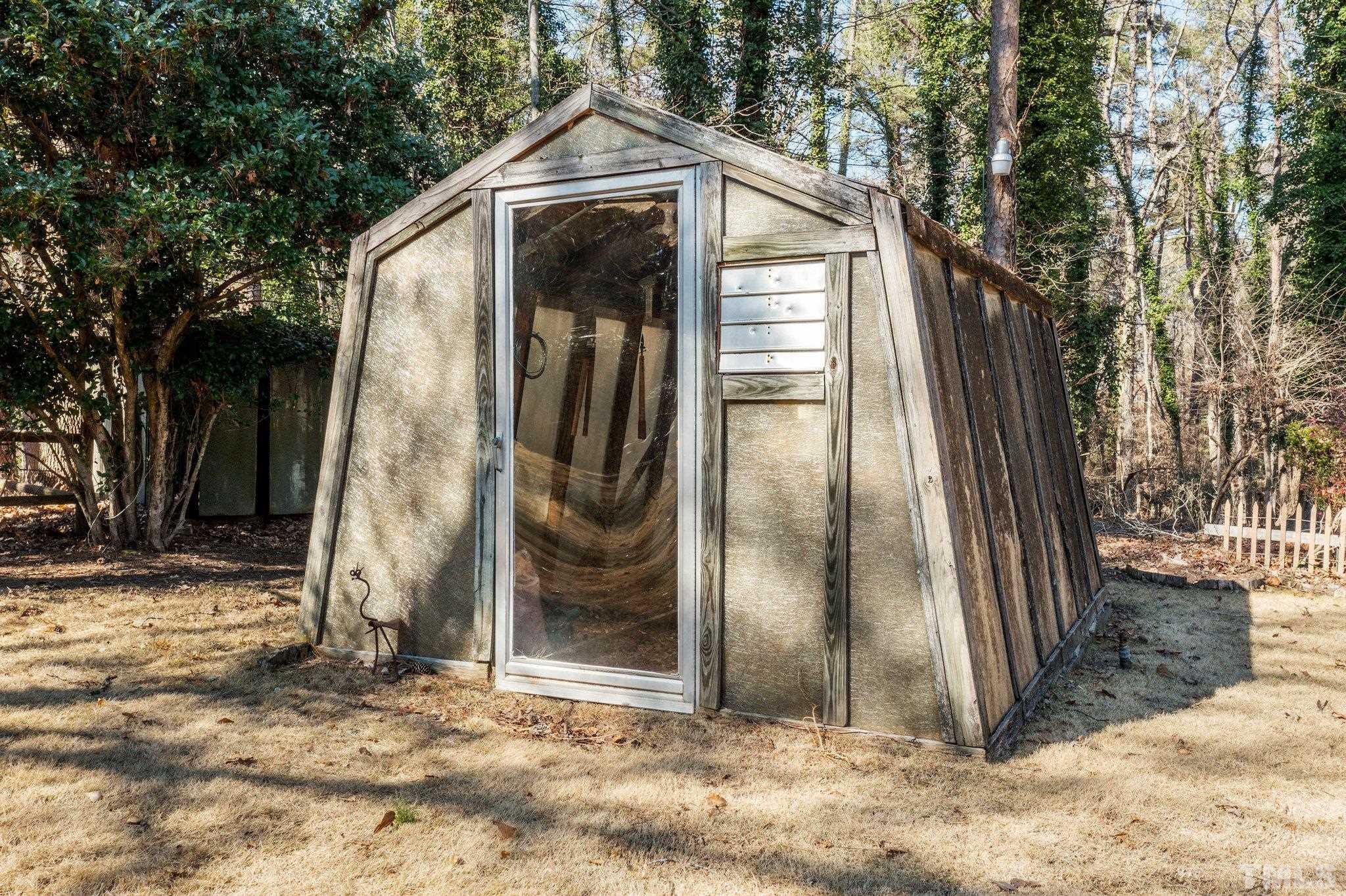 3310 Devon Road Durham, NC 27707 - Photo 49 of 50 Previous owners were gardeners who installed this greenhouse, the shed and a small building behind. All remain.