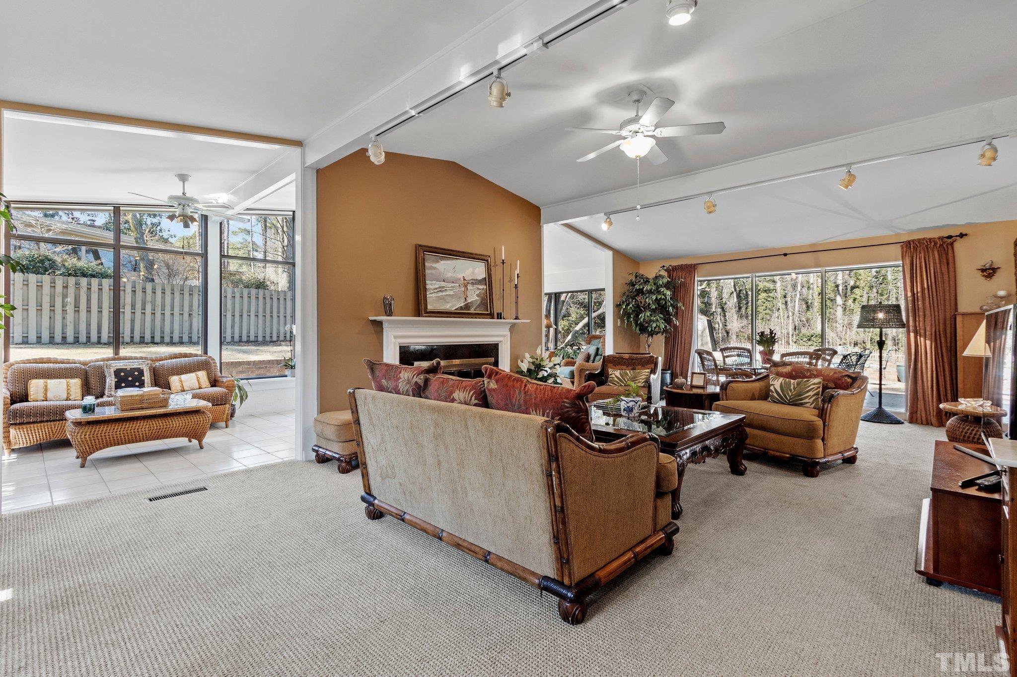 3310 Devon Road Durham, NC 27707 - Photo 8 of 50 Expansive space opens into the tiled floor sunroom with its beautiful windows.