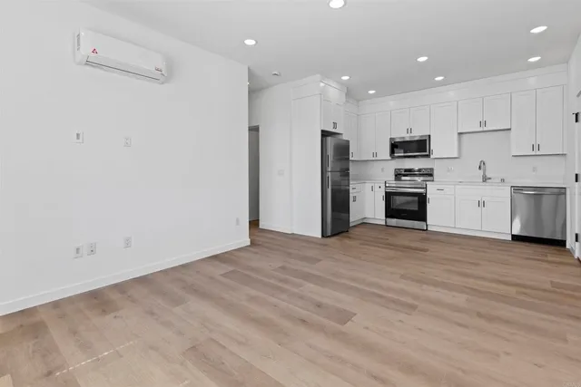 a view of kitchen with refrigerator stove microwave and cabinets