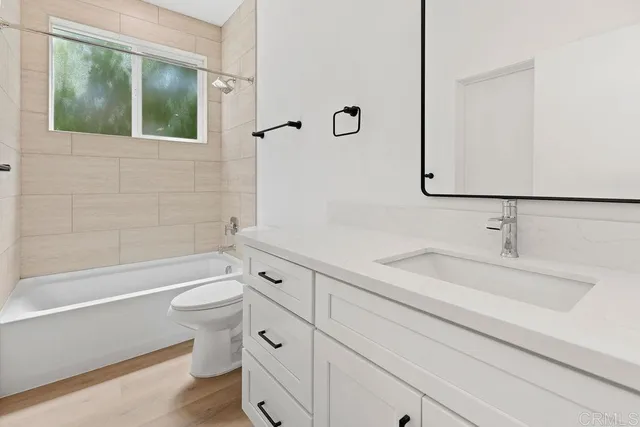 a bathroom with a sink a toilet and a bathtub