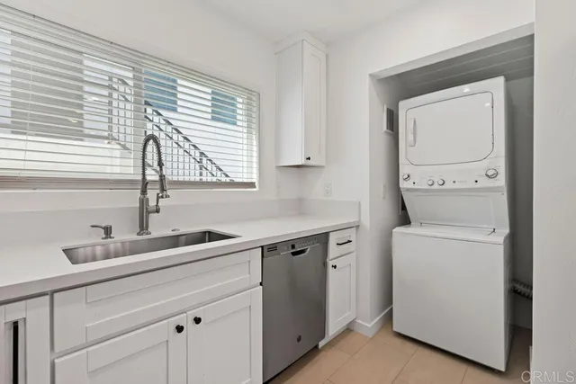 a view with cabinets a sink and a wooden floor