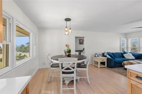 a large kitchen with stainless steel appliances a sink and a large window