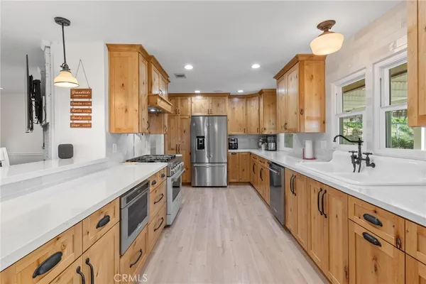 a kitchen with a stove and a wooden floor