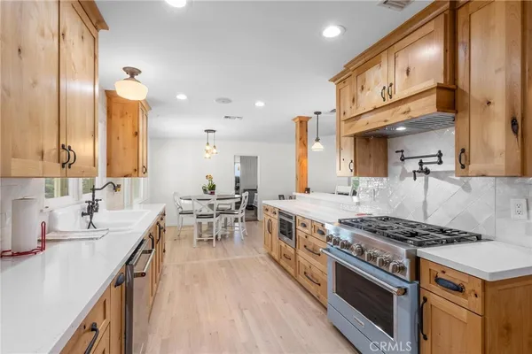 a bathroom with a granite countertop shower a toilet and a sink