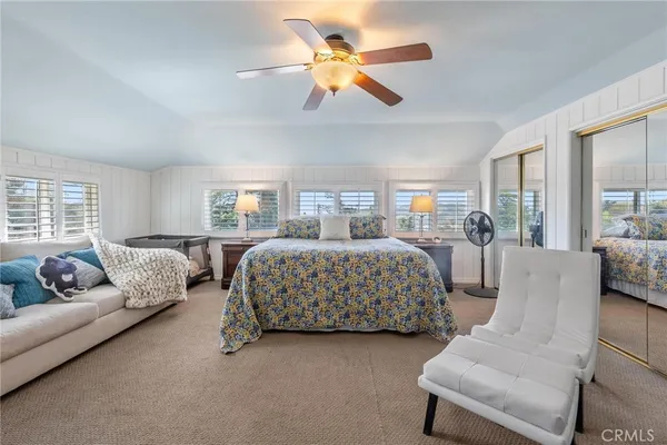 a bedroom with a bed and a couch