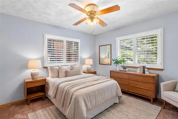 a swimming pool with outdoor seating and a lots of potted plants