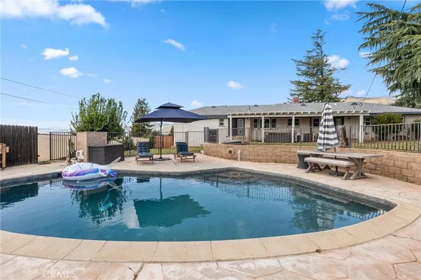 a view of house with yard and entertaining space