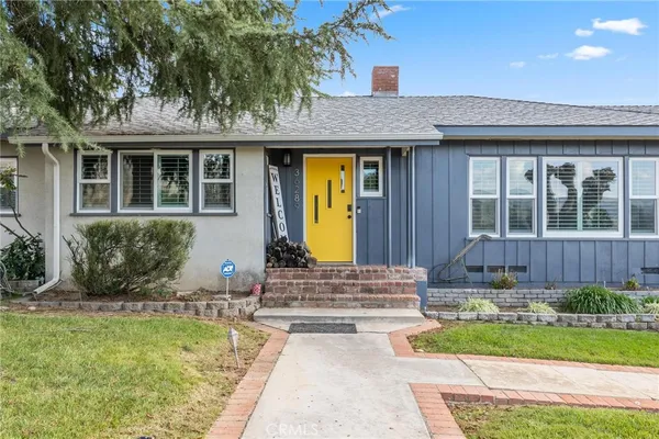 a living room with furniture a flat screen tv and a window