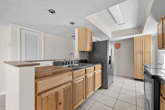 a kitchen with a sink cabinets and appliances