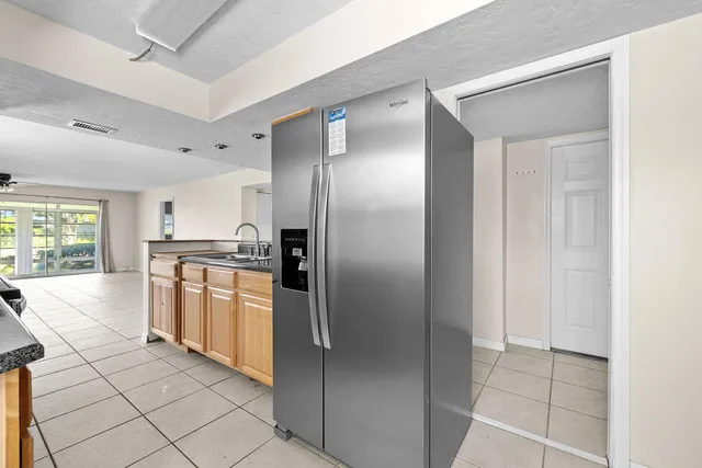 a kitchen with stainless steel appliances granite countertop a refrigerator and a sink