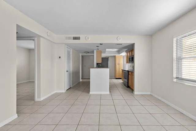 a view of a kitchen with a sink and a refrigerator window