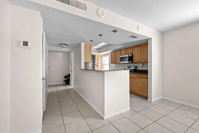 a view of a kitchen with microwave and cabinets