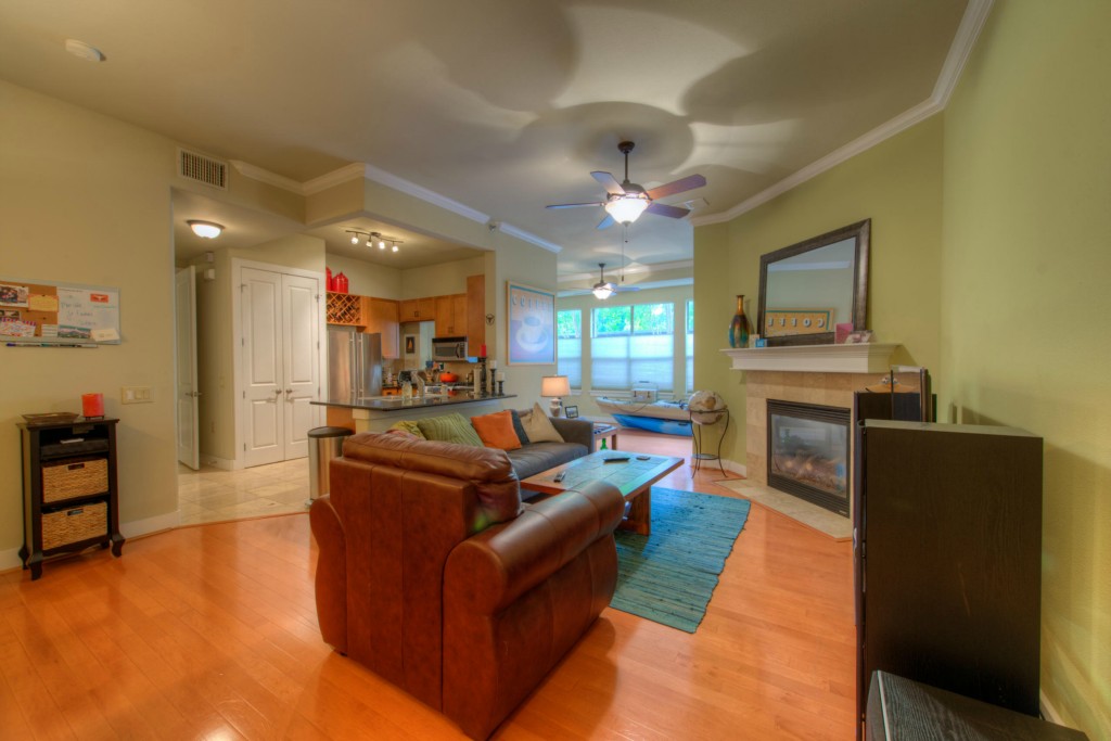 2216 Thornton Road, Unit 413 Austin, TX 78704 - Photo 1 of 1 a living room with furniture kitchen area and a fireplace