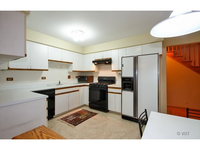 1979 Koehling Road Northbrook, IL 60062 - Photo 3 of 10 a kitchen with stainless steel appliances kitchen island granite countertop a refrigerator a sink dishwasher and a stove with wooden floor