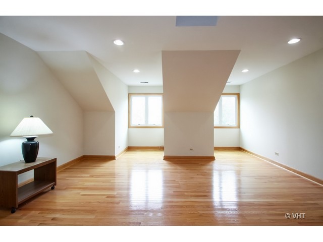 1979 Koehling Road Northbrook, IL 60062 - Photo 5 of 10 a view of an empty room with wooden floor and a window