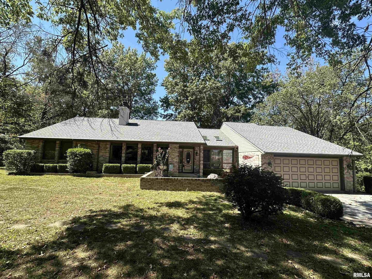 a view of a house with a yard and sitting area