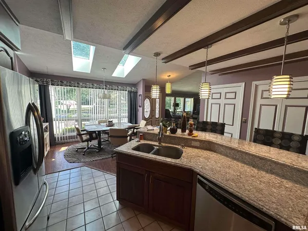 a room with musical instrument pool table chairs wooden floor and windows