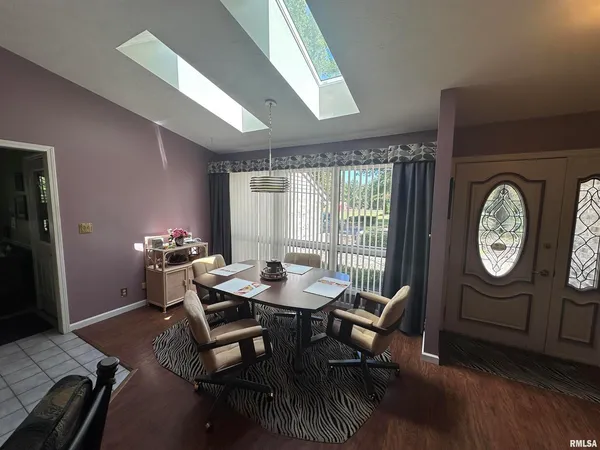 a kitchen with a dining table chairs and chairs
