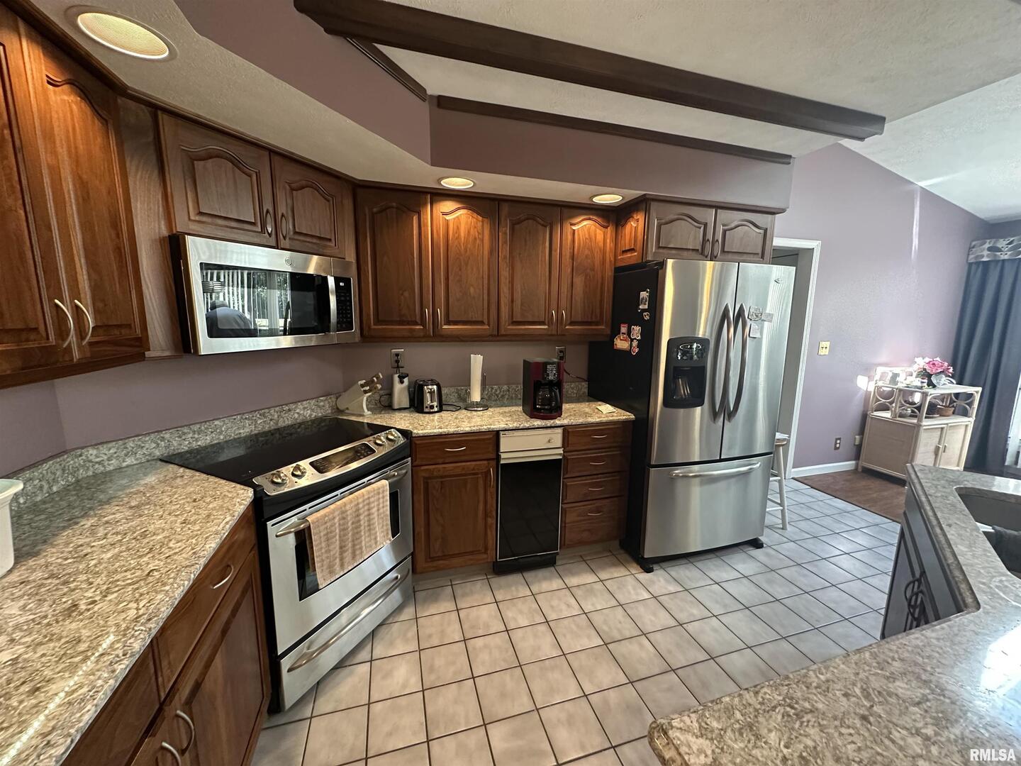 2381 Logan Street Murphysboro, IL 62966 - Photo 22 of 52 a kitchen with a stove a sink and a refrigerator