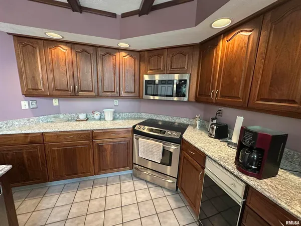 a kitchen with a sink appliances and cabinets