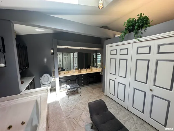 a view of a closet with wooden floor