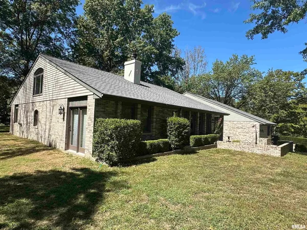 a view of a wooden house with a yard