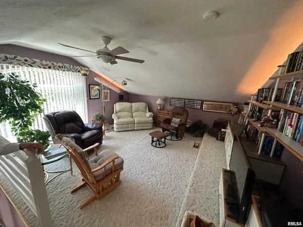 a backyard of a house with lots of furniture and baby crib