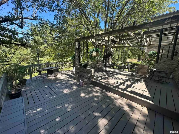 a view of a wooden deck with a yard