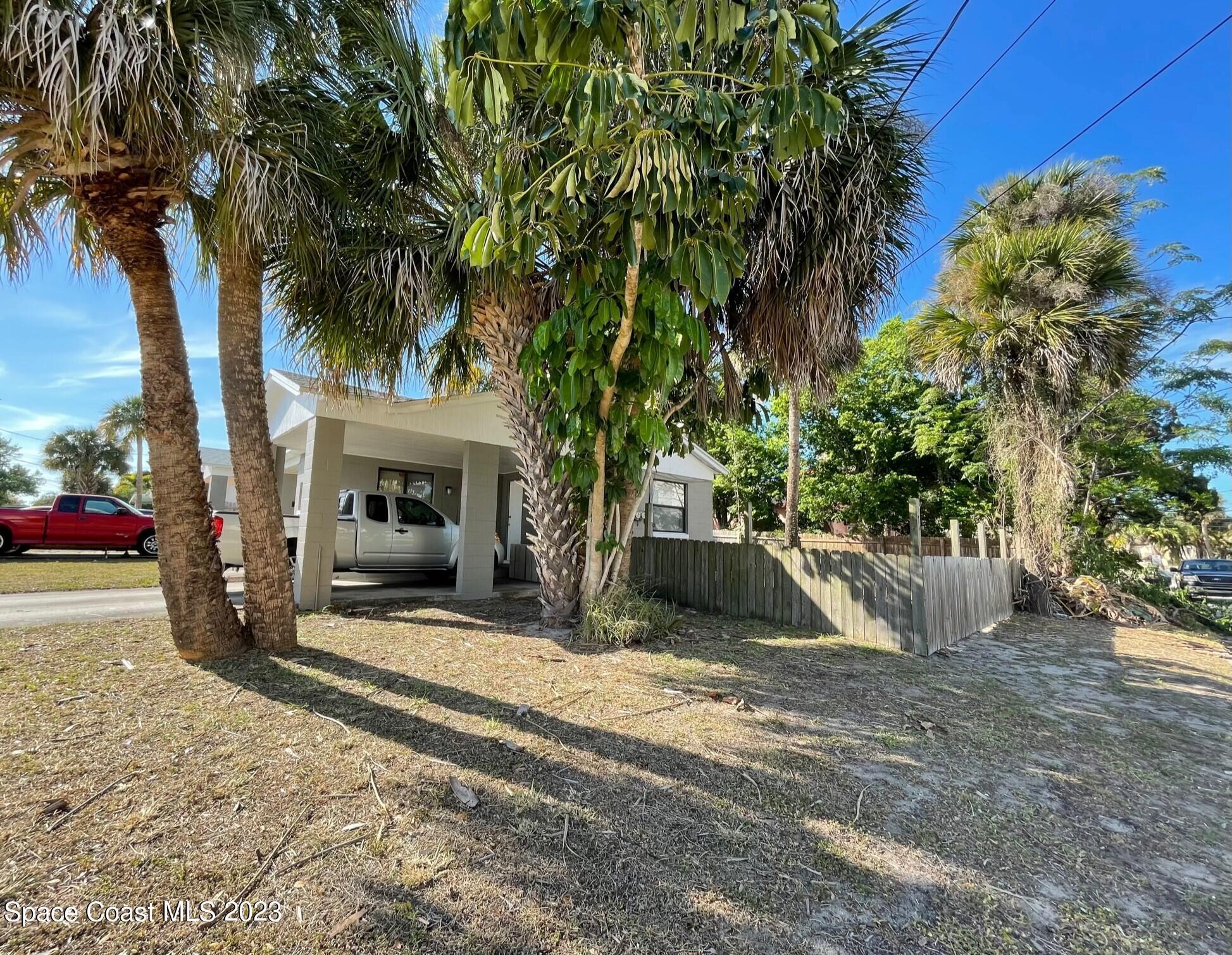 a view of a house with a tree and a yard
