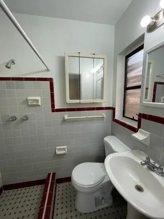a bathroom with a sink toilet and mirror