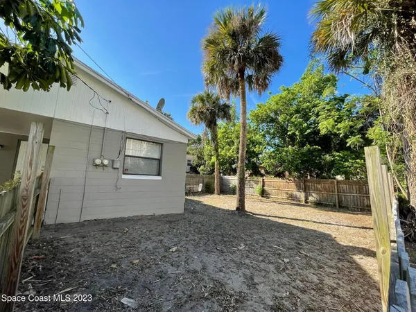 a view of a house with a yard and tree