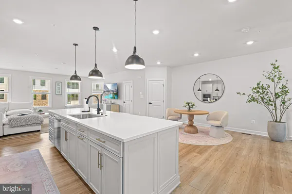 a large room with chandelier fan and a wooden floor