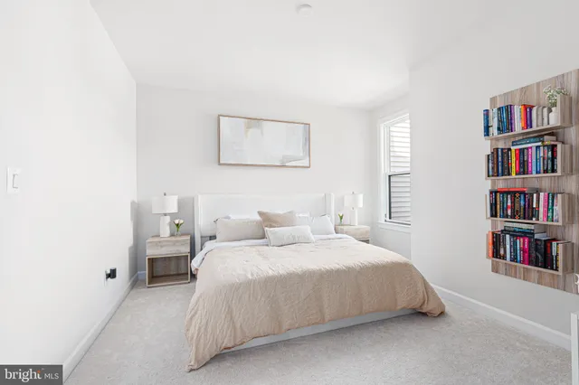 a bedroom with a bed and a book shelf